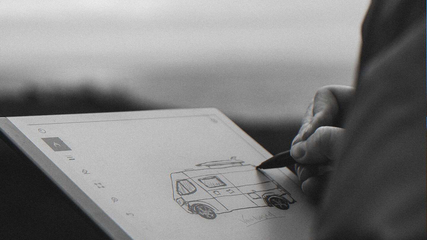 a person drawing on a piece of paper