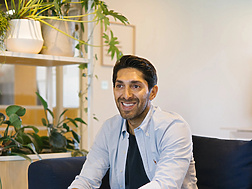 Faisal sitting on a couch