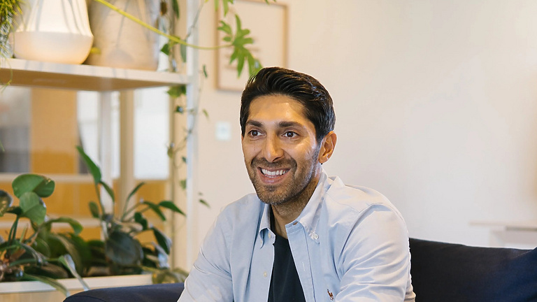 Faisal sitting on a couch