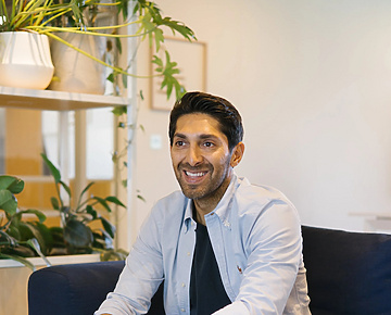 Faisal sitting on a couch