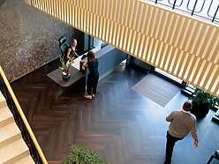a group of people standing in a lobby