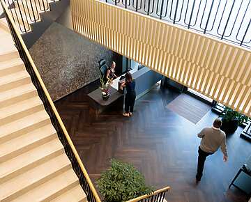 a group of people standing in a lobby