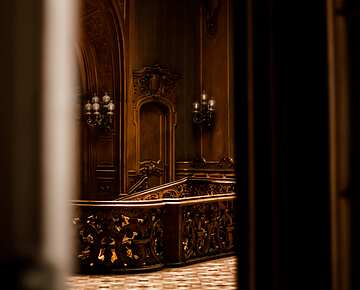Dark wooden staircase with chandelier