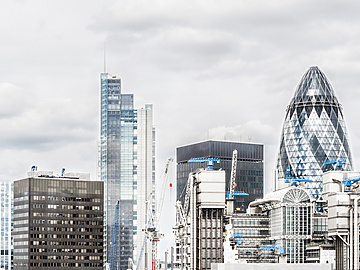 a group of tall buildings with cranes