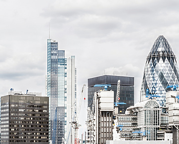 a group of tall buildings with cranes