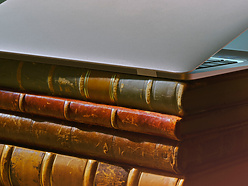 a laptop on top of a stack of books