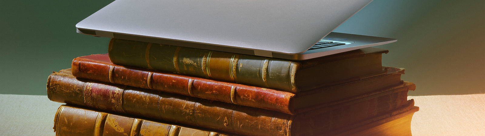a laptop on top of a stack of books