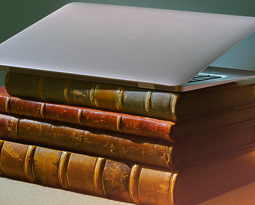 a laptop on top of a stack of books