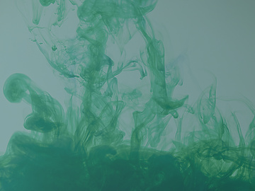 Close up abstract colour image depicting green-coloured smoke swirling around