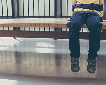 Kid sitting on a bench