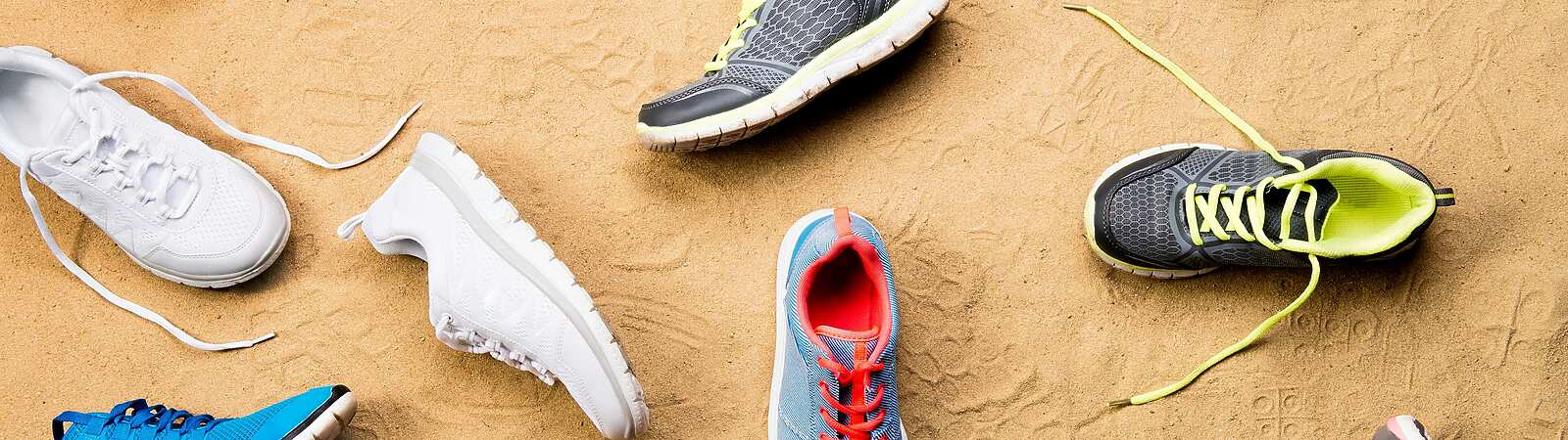 a group of shoes on the sand
