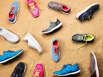 a group of shoes on the sand