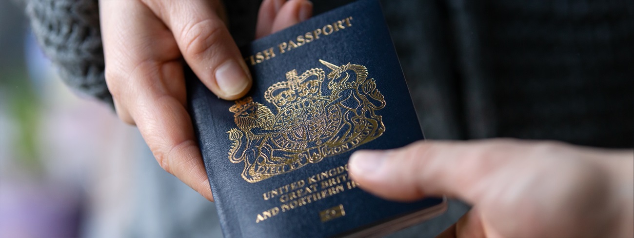 Person handing over british passport