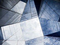looking up at a glass building
