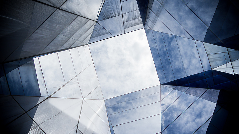 looking up at a glass building