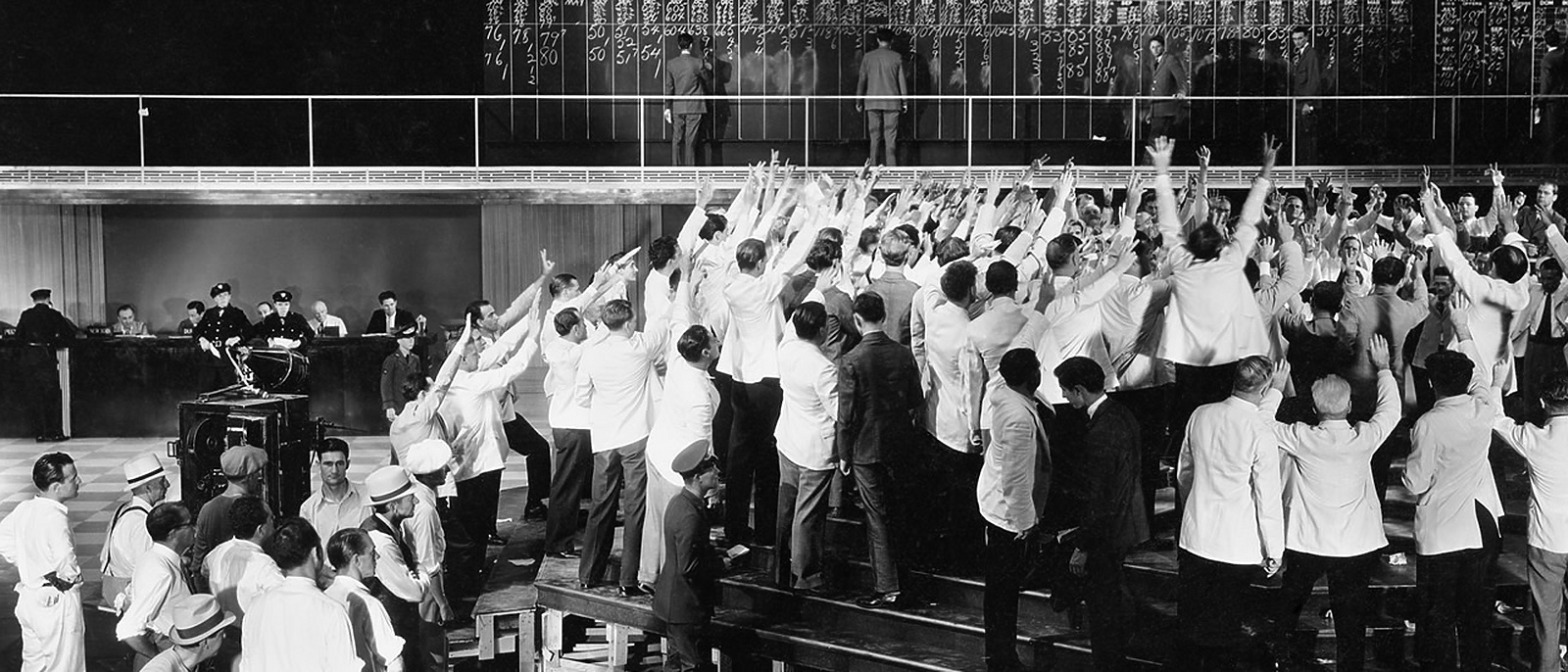 A group of people standing in a row with arms in the air