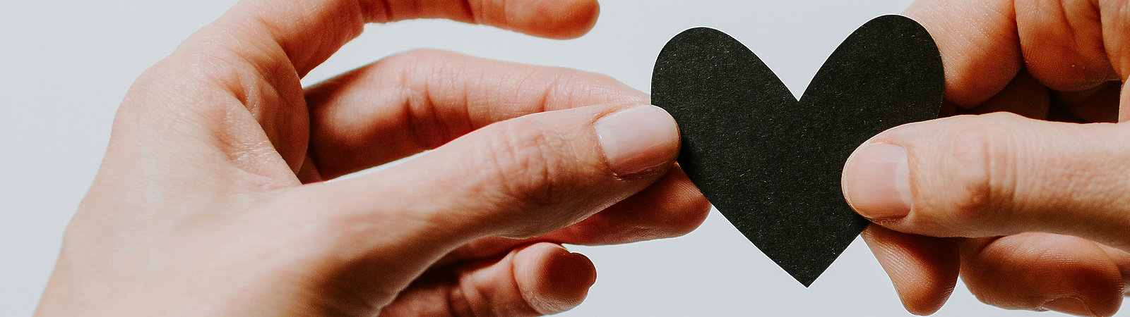 a person handing a heart to another