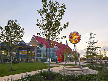 a park with trees and a building in the background