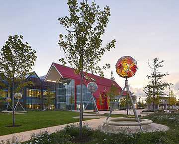 a park with trees and a building in the background