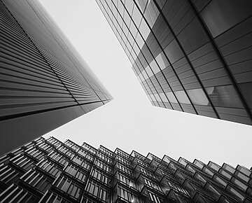 looking up view of a group of tall buildings