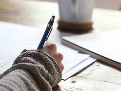 a hand holding a pen
