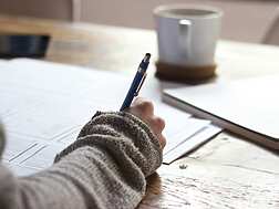a hand holding a pen
