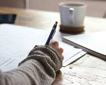 a hand holding a pen