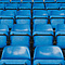 rows of blue seats in a stadium