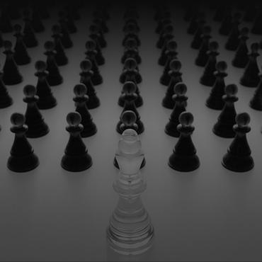 Chess pieces. Translucent King looks out over an army of pawns