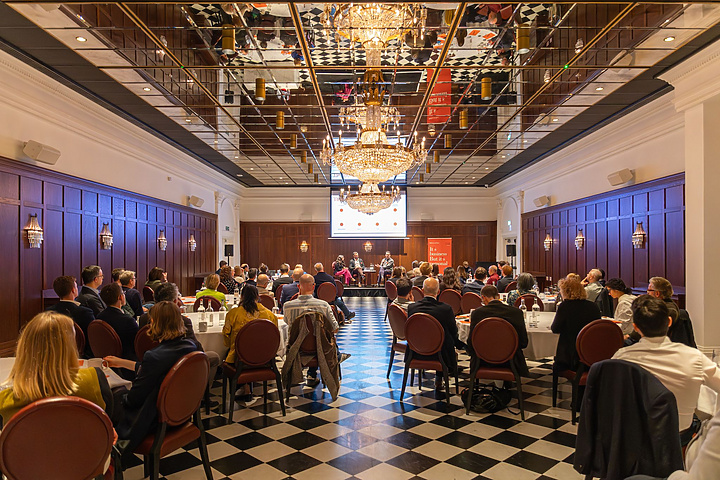 a group of people sitting at tables in a room