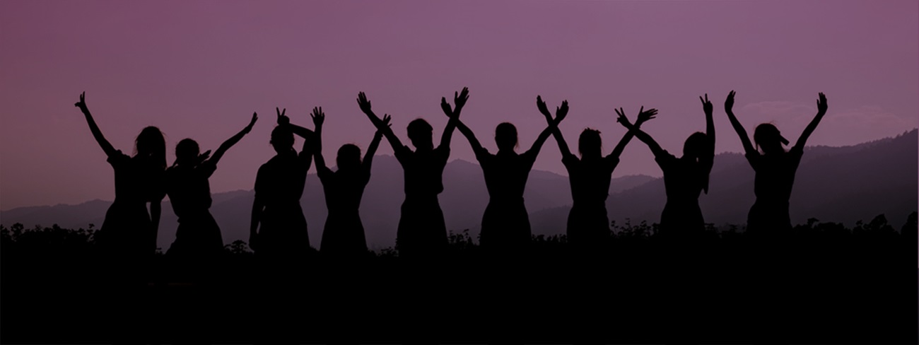 row of women holding hands up