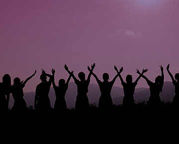 row of women holding hands up