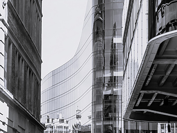 a tall glass building with a curved glass wall