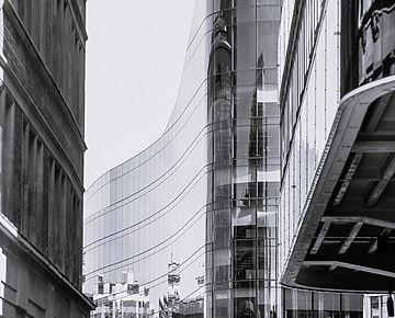 a tall glass building with a curved glass wall