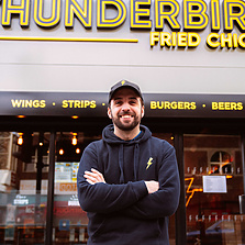 a person standing in front of a fast food restaurant