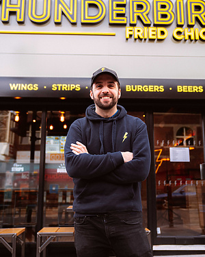 a person standing in front of a fast food restaurant
