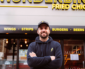 a person standing in front of a fast food restaurant