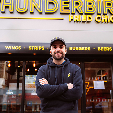 a person standing in front of a fast food restaurant
