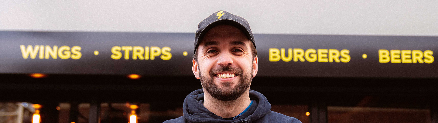 a person standing in front of a fast food restaurant