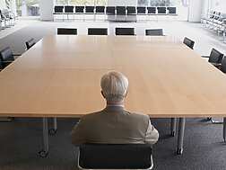 A man on his own in a meeting room