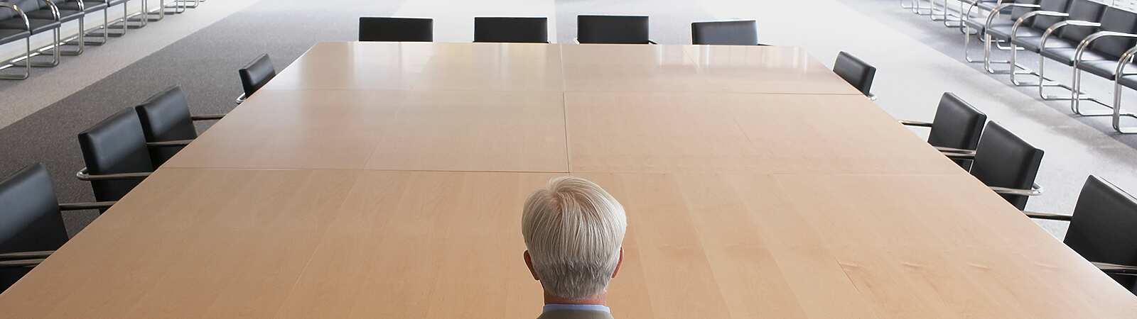 A man on his own in a meeting room