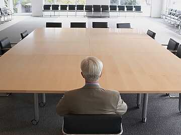 A man on his own in a meeting room