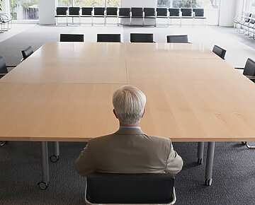 A man on his own in a meeting room