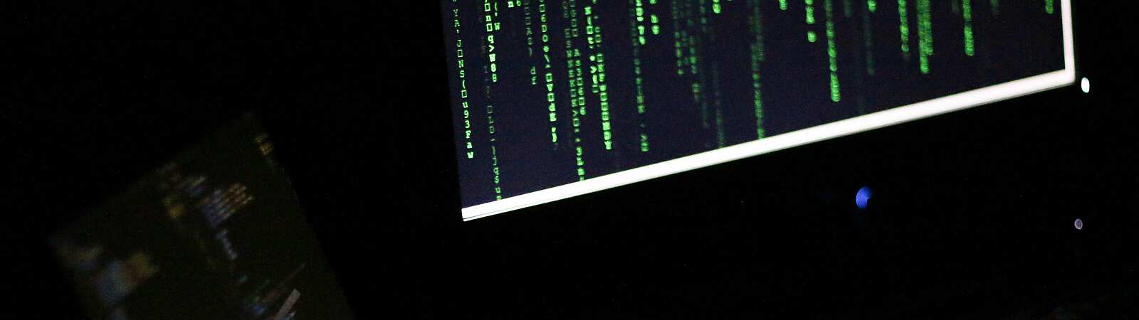 Two laptops in a dark room