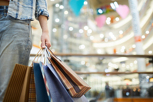 Man holding four shopping bags