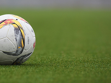 Football on green field