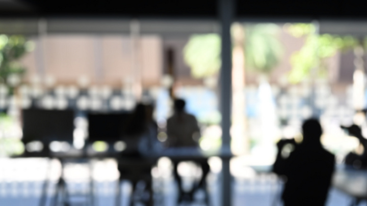 a blurry image of a person sitting at a table