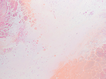 a pink and white liquid with white and pink streaks