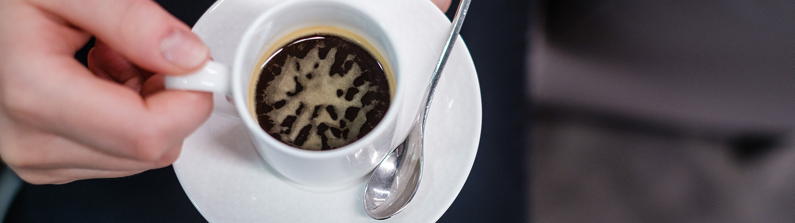 a person holding a cup of coffee