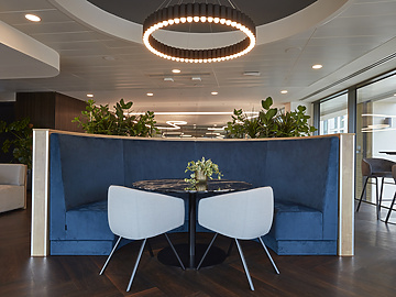 a round table with chairs and a chandelier in a room